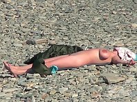 Nu1923# A few girls are sunbathing on the beach. One has gorgeous big tits. She is definitely the st