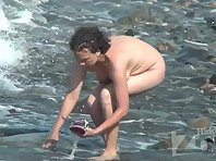 Nu2095# We are again on a nudist beach. A pregnant woman walks along the shore. Her tits with dark n