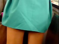 Up1775# Tanned babe in a wide green skirt. I photographed her crotch with backlight. Beautiful tan