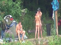 Nu1262# Two men and a woman resting near they tent at nude beach voyeur. The girl obviously stick 