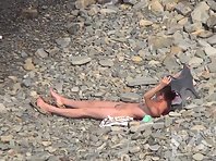 Nu1534# Another naked girl sunbathing on the beach. She put off her tits and pussy shaggy. Perhaps