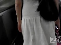 Up1999# Slender blonde in a short white dress. Nice ass in white panties. On escalator can shoot g