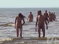 Nu2025# Our camera continues to work on the beach. Nudists come out of the water facing the camera a