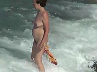 Nu2082# We continue to admire the pregnant woman. She walks along the beach, turns to the camera and
