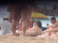 Nu1321# A young pretty woman lights a cigarette at a nudist beach. Excellent model for nude beach 