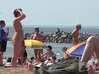 Nu1330# Shooting of a hidden camera at a nude beach. In the frame gets a beautiful naked girl with