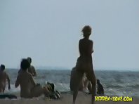 Nu1236# Beautiful naked girl reading a magazine on the background of the rolling waves. Somehow it