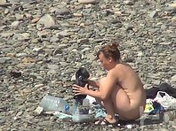 Nu2215# The camera shoots alternately several girls on a nudist beach. But the operator devotes more