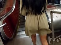 Up2986# Under the skirt of a tanned brunette in a short beige dress. Our hidden camera caught her ro