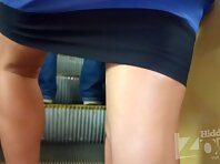 Up2763#Under the skirt of a tanned blonde in a short blue dress. The girl stood wide apart. 