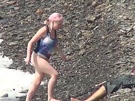 Nu2215#The camera shoots alternately several girls on a nudist beach. But the operator devot