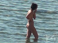 Nu1829#The girl went into the sea, and sat down. Most likely she pee in the water. Her boyfr