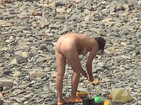 Nu2177#Nudists on the beach go about their business. Our camera monitors them and does not m