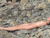 Nu2169#Our hidden camera switched to a pretty brunette. She sunbathes among the rocks and li